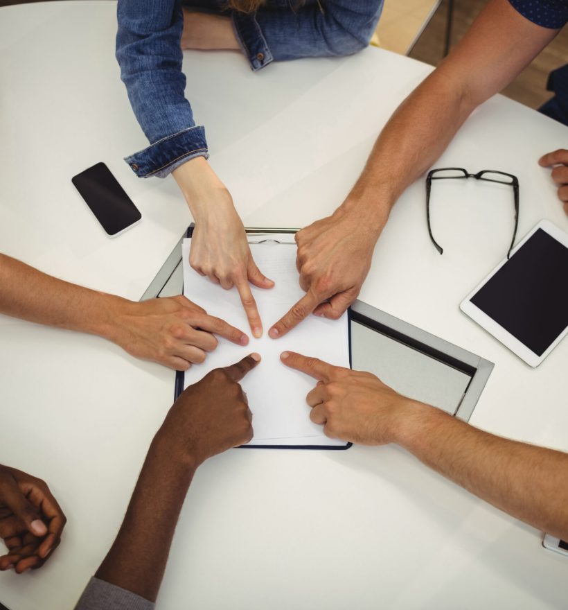 Business executives pointing on clipboard in office